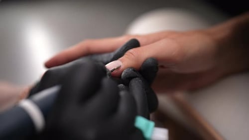Nail Technician Performing Nail Treatment in Salon