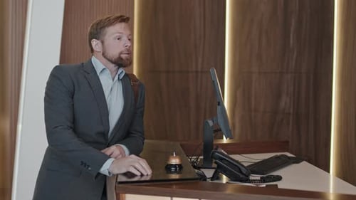 Young Adult Man Calling For Hotel Receptionist
