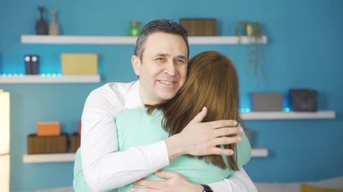 Man and Woman Embrace in Warm Home Setting