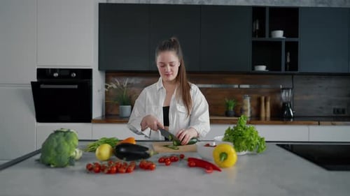Woman Chops Vegetables and Dances in Kitchen