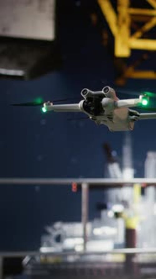 Vertical Video Professional Drone Operators Flies a UAV Around a Drilling Rig