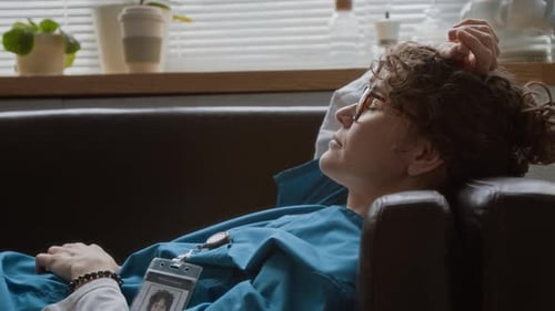 Tired Doctor Resting on Couch