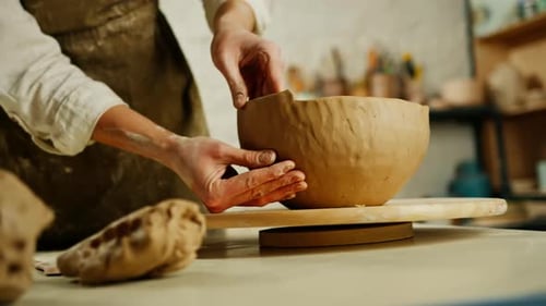 Creating handicraft pottery closeup of working table in ceramics studio with female master