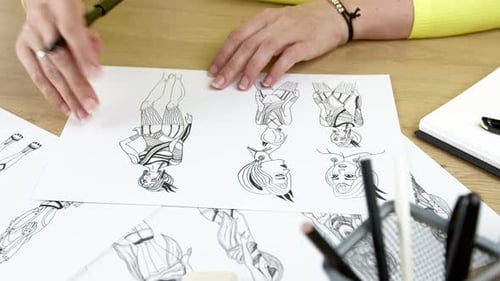 Fashion Designer Sketching Elegant Designs at Desk