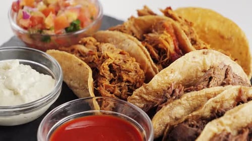 Tacos with Shredded Meat and Three Different Sauces