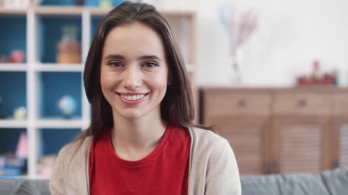 Close Up Face Young Woman Look at Camera Smiling Feel Happy Sit on Sofa at Home Portrait Shot