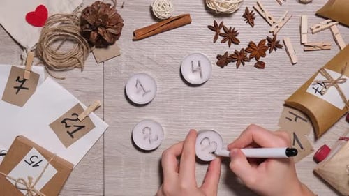 Unrecognizable Young Woman Paint Numbers on Candles