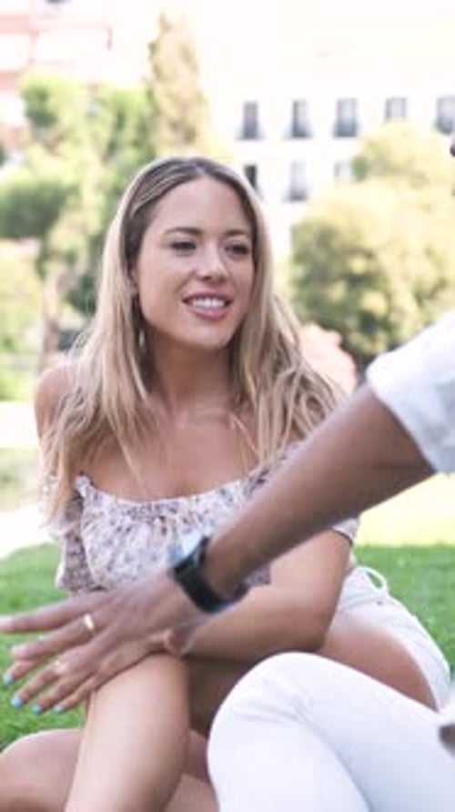 Multiethnic Friends Talking While Sitting at City Park During Daytime