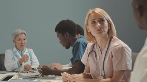 Multiethnic Medical Team Having Meeting with Head Doctor in Clinic