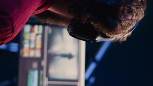 Man Wearing Headphones Working on a Computer