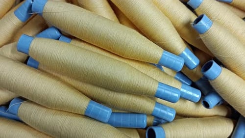 Cream Colored Thread Spools Close Up