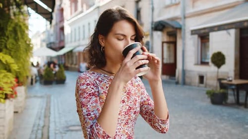 Caucasian Woman Enjoying Drinking Morning Coffee Hot Drink Relaxing Taking a Break in City Street