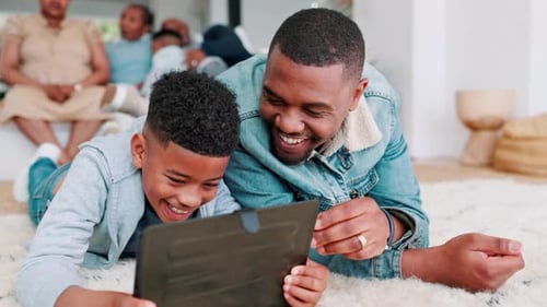 Father and Son Using Tablet at Home