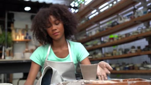 People Creating Pottery in Studio. Female artisan creating handmade ceramics in pottery workshop