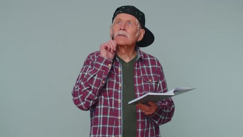 Senior Man Taking Notes and Giving Thumbs Up