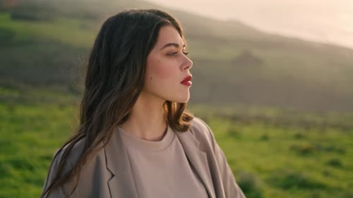 Thoughtful Woman Gazing into Distance in Rural Landscape