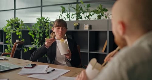 Woman and Man Eating Take Out at Work