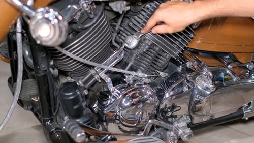 A Male Mechanic Repairs His Motorcycle in a Garage Retro Motorcycle Service