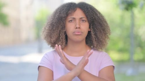Outdoor Portrait of Young African Woman Rejecting and Disliking