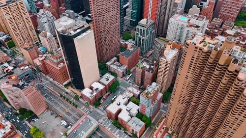 Densely built neighborhoods of New York with busy streets among them.