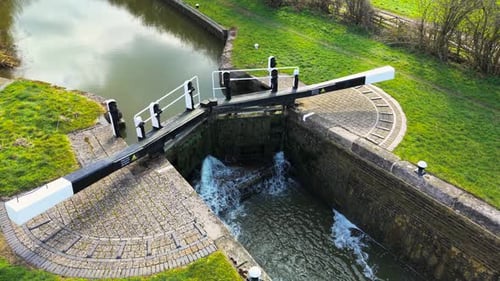 Aerial View Canal Lock in Operation Overhead Shot Sluice Gate Releasing Water Topdown Perspective