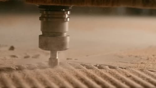 Close-up of automated machine cutting wooden board