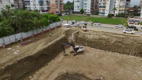 Aerial View TimeLapse of Excavators Digging Foundation at Busy Construction Site