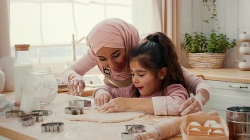 Mother and Daughter Share a Joyful Baking Moment in a Cozy Kitchen