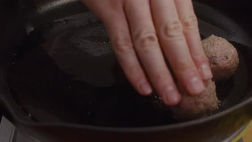 Placing Meatballs into a Cast Iron Pan