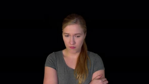 Sad Woman Looking Down in Studio Close Up