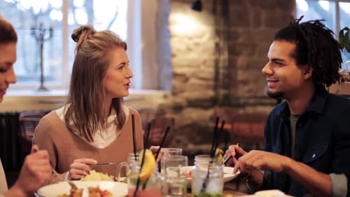 Friends Enjoying Lunch Together in Restaurant