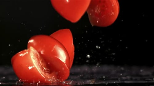 Tomato Slices Fall on the Table Filmed is Slow Motion 1000 Fps