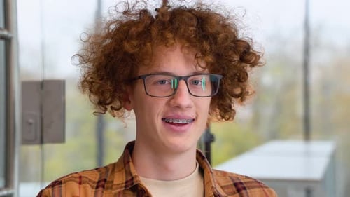 Smiling Teen with Braces and Curly Hair