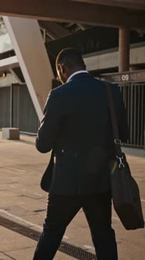 Confident Unrecognizable Black Businessman Going Along Evening City Back View Slow Motion Sun Flare