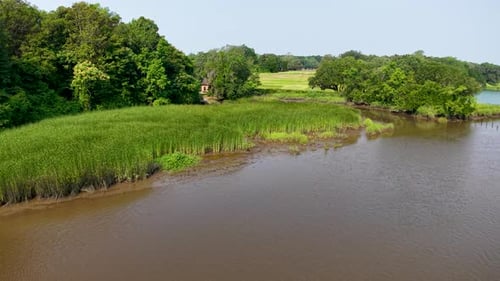 Aerial view of muddy river with green banks near Charleston SC
