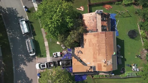 Element of Roofers Installing a New Roof on an Building Drone Wide Shot