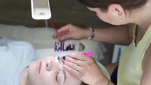 Aesthetician Applying Eyelash Extensions in a Beauty Salon