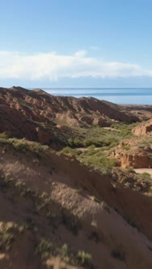 Flying Fast Over Red Canyon and Road at Sunny Day Aerial View Vertical Video
