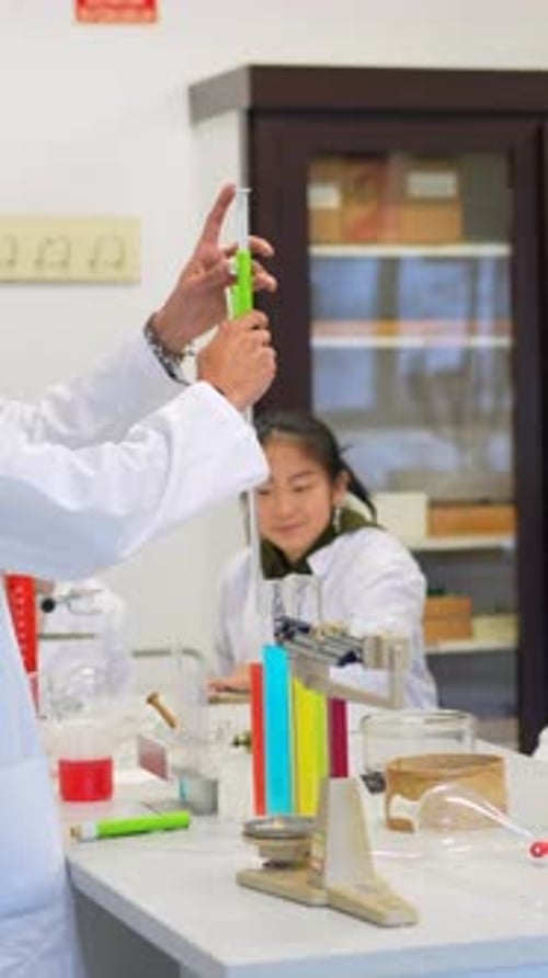 Science Instructor with Students in School Laboratory