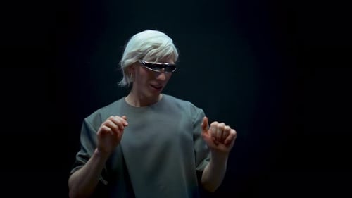 Man Wearing Futuristic Glasses Interacts with Virtual Interface