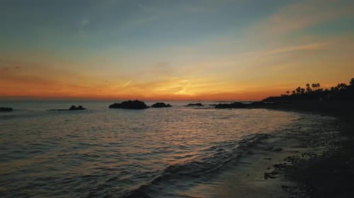 Sunset at the beach with golden sky
