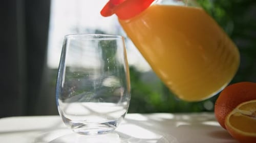 Fresh Squeezed Orange Juice Into Glass Close Up