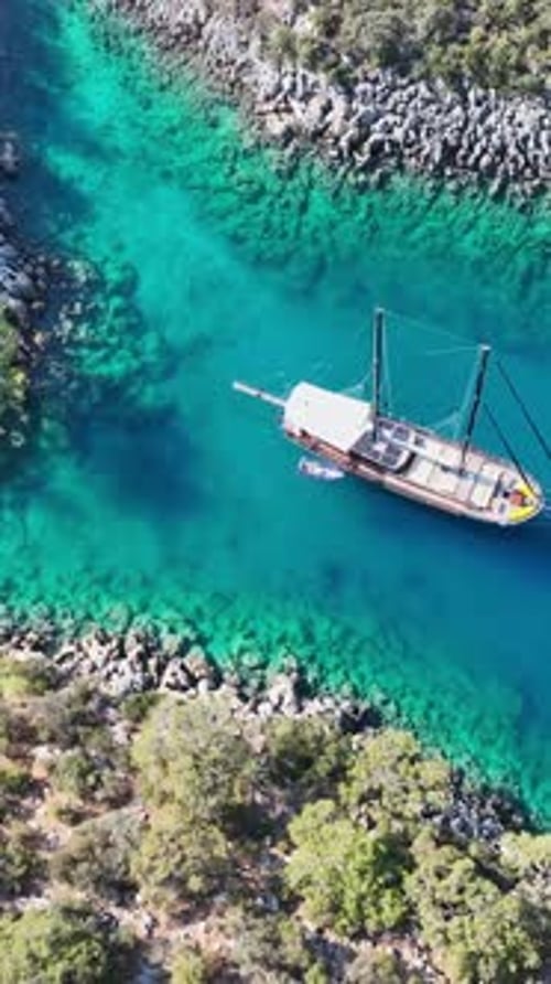 Aerial vertical video of gulet at sea