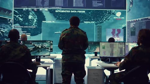 Figures Analyzing Data in Futuristic Control Center