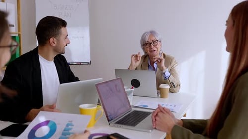 Business Team Collaborates on a Business Plan in Office