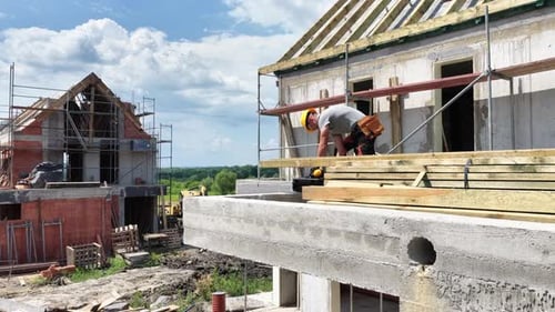 Construction Workers Building Homes in a Suburban Development During the Day