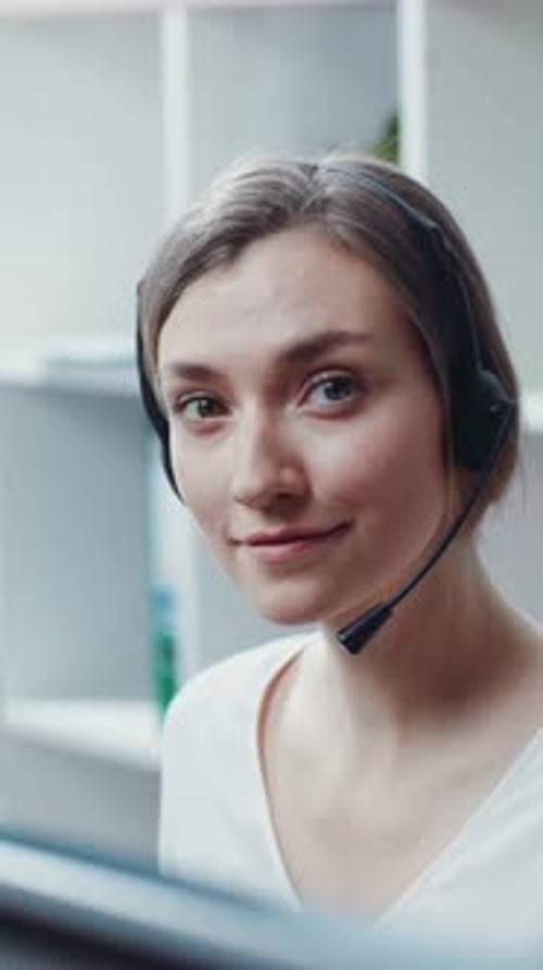 Smiling Woman Wearing Headset in Office Setting
