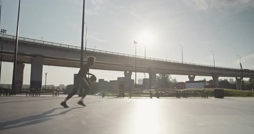 Athlete Dunks Basketball on Outdoor Urban Court
