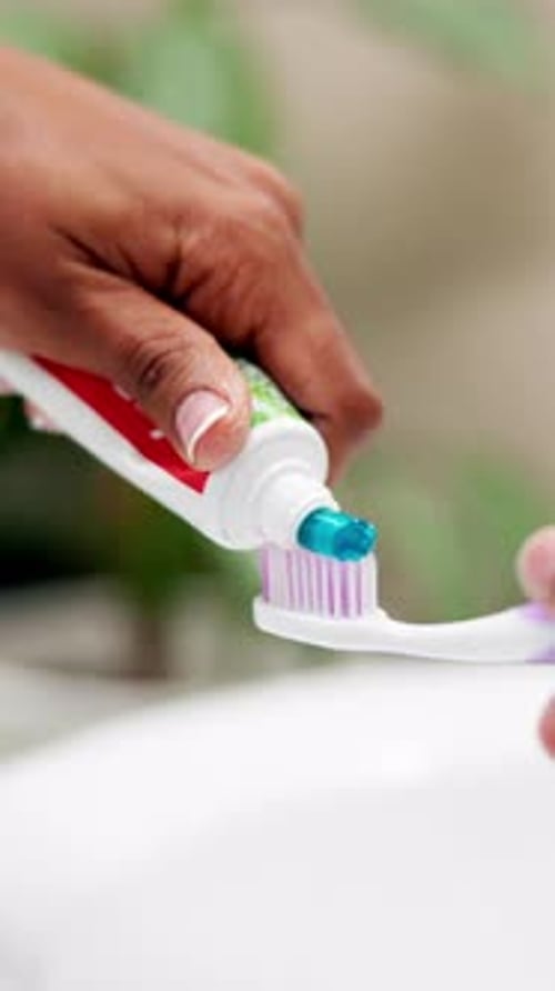 Hands, toothpaste and toothbrush in bathroom, home or product for cleaning mouth