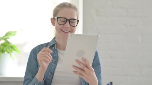 Woman Uses Tablet for Video Call Indoors